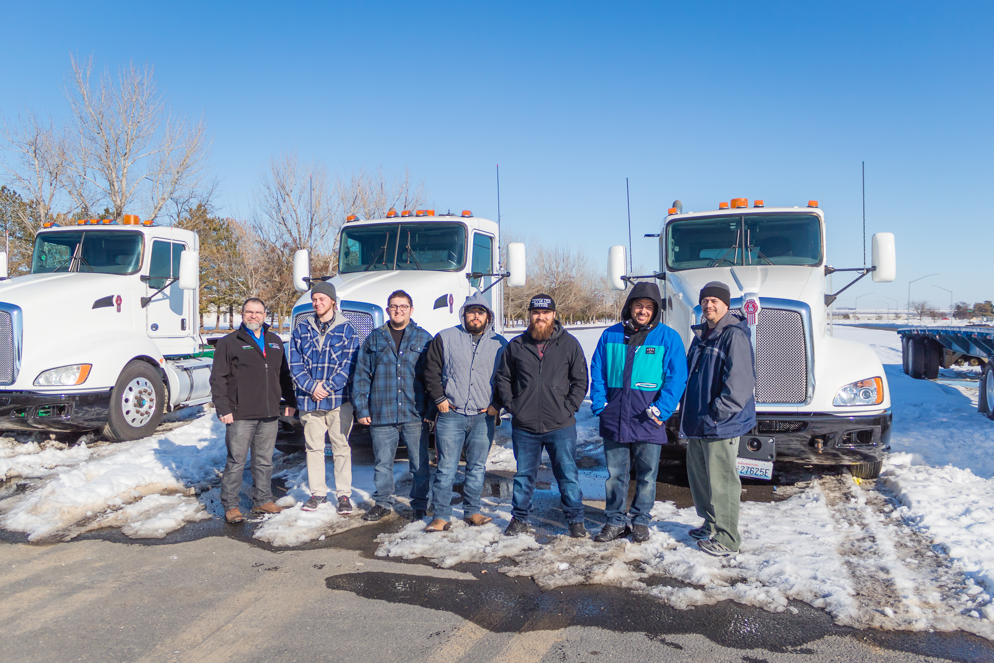 Students in front of several semi trucks lined up