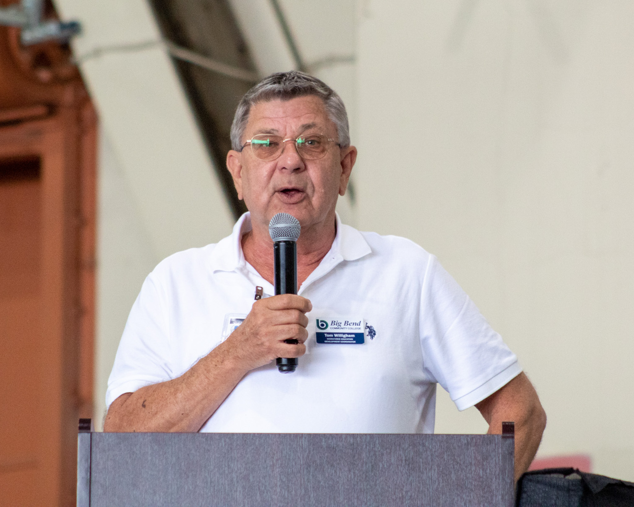 Big Bend Community College Workforce Education Development Coordinator Tom Willingham holds the microphone as he speaks to students at Boeing Wednesday.