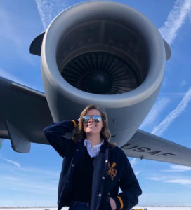 Female pilot under plane engine