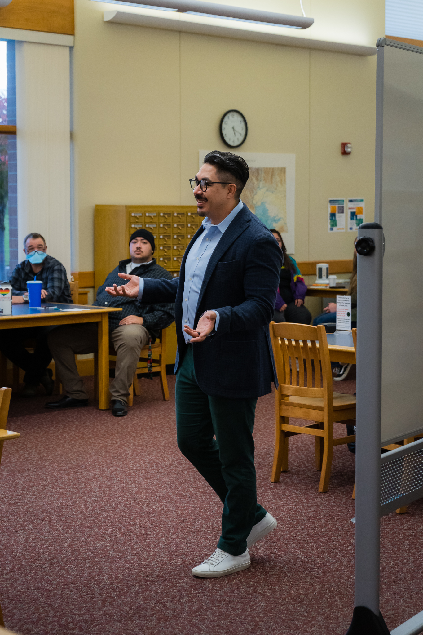 BBCC alum Ricardo Ruiz speaking to audience in library