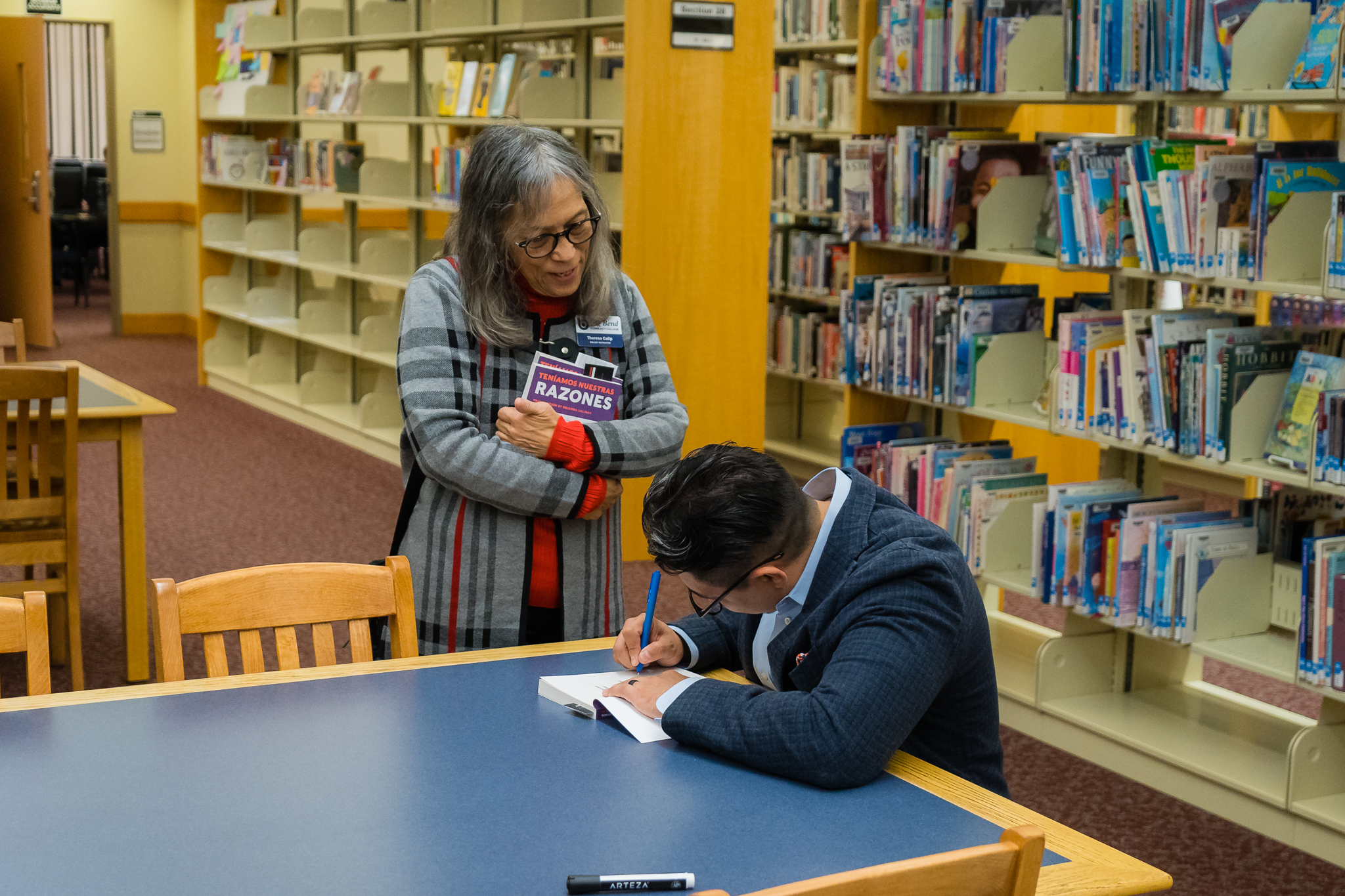 Ricardo Ruiz signs a book